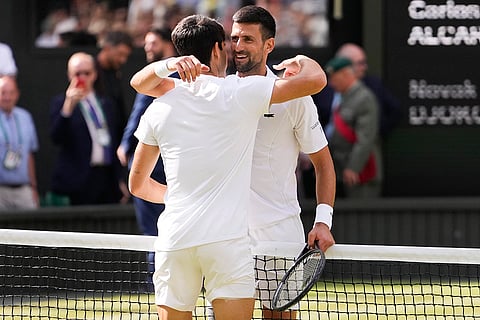 Carlos Alcaraz is congratulated by Novak Djokovic